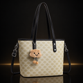 Light beige floral tote with subtle gold and mirror reflection